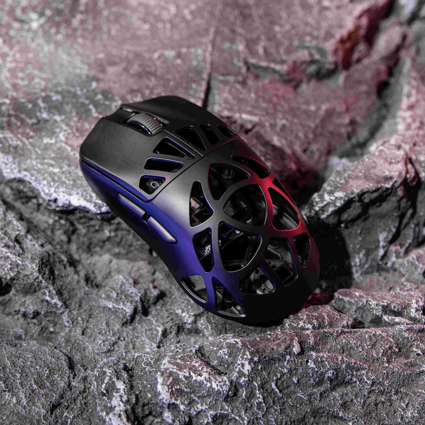 EPOMAKER CarbonX Mouse Black lifestyle shot on rocks with red and blue RGB lighting